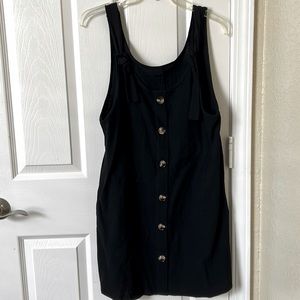 Black dress with adjustable tie straps, fits like a medium, brown buttons